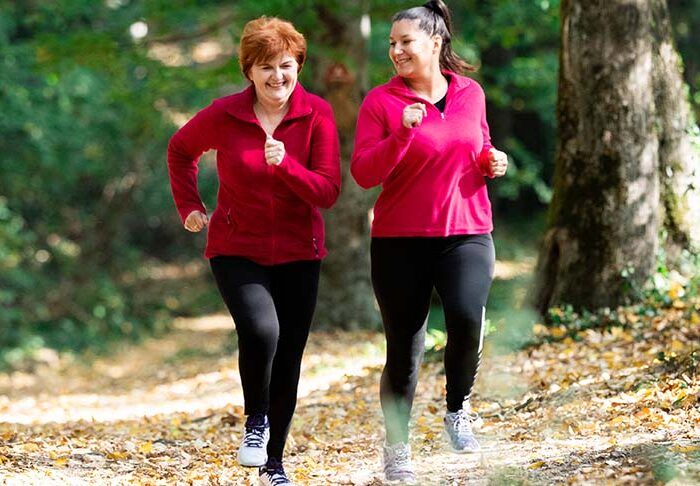 Dwie kobiety biegną po lesie